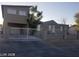 View of two-story home featuring neutral paint, fenced yard and gated entry at 3439 Cox St, North Las Vegas, NV 89032