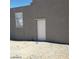 Exterior of the home showing a white door and window on a gray stucco wall at 3439 Cox St, North Las Vegas, NV 89032