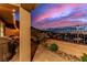 Stylish backyard with artificial turf, mountain views, brick-paved patio, string lights, and seating at 360 Rosefinch St, Henderson, NV 89012