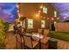 Inviting backyard with a fire pit, artificial turf, brick-paved patio, string lights, and mountain views at 360 Rosefinch St, Henderson, NV 89012