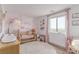 Charming Bedroom features a crib, area rug, and a scenic view from the window at 360 Rosefinch St, Henderson, NV 89012