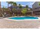 Inviting community pool with palm trees, lounge chairs, mountain views, and a pergola covered picnic area at 360 Rosefinch St, Henderson, NV 89012