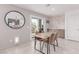 Dining area with a modern table, stylish chairs, and a view of the kitchen at 360 Rosefinch St, Henderson, NV 89012