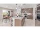 Well-lit kitchen with a large island, stainless steel appliances, and a view to the dining area at 360 Rosefinch St, Henderson, NV 89012