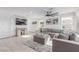 Bright living room featuring a comfortable gray sectional, modern ceiling fan, and neutral decor at 360 Rosefinch St, Henderson, NV 89012