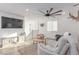 Bright living room boasts wood floors, comfortable seating, decor, and an updated ceiling fan at 360 Rosefinch St, Henderson, NV 89012