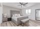 Bedroom with a gray upholstered bed, neutral decor, and wood flooring at 360 Rosefinch St, Henderson, NV 89012