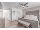 Comfortable main bedroom features a ceiling fan, wood floors, and a beautifully upholstered bed with cushioned headboard at 360 Rosefinch St, Henderson, NV 89012