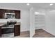 Functional kitchen space with stainless steel appliances, granite countertops, and adjacent pantry for storage at 3677 Via El Monte Ave, Las Vegas, NV 89115