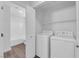 Convenient laundry area featuring a washer, dryer, and ample shelving for storage at 3677 Via El Monte Ave, Las Vegas, NV 89115