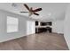Bright and airy living area featuring sleek vinyl floors, contemporary ceiling fan, and natural light from large windows at 3677 Via El Monte Ave, Las Vegas, NV 89115