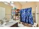 Bathroom with a vanity, mirror, and shower with a blue patterned curtain at 4217 Bridesmaid Falls Ave, North Las Vegas, NV 89085