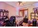 Cozy bedroom featuring a ceiling fan, carpeted floor, and natural light from the window at 4217 Bridesmaid Falls Ave, North Las Vegas, NV 89085