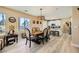 Bright dining area with a wooden table, seating for six, and large windows providing natural light at 4217 Bridesmaid Falls Ave, North Las Vegas, NV 89085