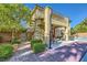 Beautiful two-story home featuring a spiral staircase, outdoor patio, and lush landscaping at 4217 Bridesmaid Falls Ave, North Las Vegas, NV 89085