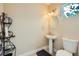 Cozy half bathroom with a pedestal sink, decorative shelving, and a neutral color scheme at 4217 Bridesmaid Falls Ave, North Las Vegas, NV 89085