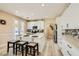 Bright kitchen featuring white cabinetry, a center island with bar stools, and modern countertops at 4217 Bridesmaid Falls Ave, North Las Vegas, NV 89085