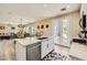 Open-concept kitchen with a center island, modern appliances, and seamless flow into the dining and living areas at 4217 Bridesmaid Falls Ave, North Las Vegas, NV 89085