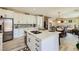 Well-lit kitchen with white cabinets, a center island with seating, and an adjacent dining area at 4217 Bridesmaid Falls Ave, North Las Vegas, NV 89085