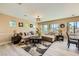 Spacious living room with large windows, wood-look floors and comfortable seating at 4217 Bridesmaid Falls Ave, North Las Vegas, NV 89085