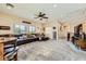 Open living room with a large sofa, movie-themed decor, and staircase access to the upper level at 4217 Bridesmaid Falls Ave, North Las Vegas, NV 89085