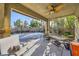 Covered outdoor patio featuring lounge seating, spiral staircase, and a view of the basketball court at 4217 Bridesmaid Falls Ave, North Las Vegas, NV 89085