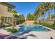 Sparkling pool area featuring palm trees, a spa, and lush landscaping at 4217 Bridesmaid Falls Ave, North Las Vegas, NV 89085