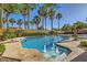 Backyard pool with palm trees, water features, and ample space for outdoor enjoyment at 4217 Bridesmaid Falls Ave, North Las Vegas, NV 89085