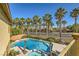 Elevated view of a pool and spa bordered by palm trees, showcasing a serene backyard at 4217 Bridesmaid Falls Ave, North Las Vegas, NV 89085