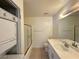A functional bathroom with a shower/tub combo, vanity, and included washer-dryer setup at 4230 Gannet Cir # 216, Las Vegas, NV 89103