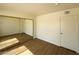 A spacious bedroom with a closet that has mirrored doors and modern flooring at 4230 Gannet Cir # 216, Las Vegas, NV 89103