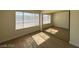 A bright bedroom with modern flooring, a large window, and mirrored closet doors at 4230 Gannet Cir # 216, Las Vegas, NV 89103