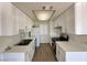 A modern kitchen featuring white cabinets, stainless steel appliances and bright countertops at 4230 Gannet Cir # 216, Las Vegas, NV 89103