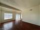 A bright living room with hardwood floors, vaulted ceilings, and sliding door access to outdoors at 4230 Gannet Cir # 216, Las Vegas, NV 89103