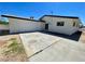 Back exterior of home, showcasing large garage, concrete driveway and neutral paint at 4324 El Conlon Ave, Las Vegas, NV 89102