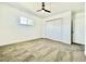 Bright bedroom features plush carpet, a ceiling fan, and a large closet at 4324 El Conlon Ave, Las Vegas, NV 89102