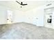 Spacious bedroom with carpet, ceiling fan and doorways to bathroom and hallway at 4324 El Conlon Ave, Las Vegas, NV 89102