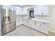 Clean kitchen features white cabinets, stainless steel refrigerator, and stylish countertops at 4324 El Conlon Ave, Las Vegas, NV 89102