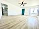 Spacious living room boasts modern flooring, a teal door, and an abundance of natural light at 4324 El Conlon Ave, Las Vegas, NV 89102