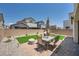 Private backyard with synthetic grass, brick paver patio, and lush landscaping at 4364 Contour Bend Ave, North Las Vegas, NV 89084