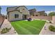 Expansive backyard with artificial grass and brick-paved patio, perfect for relaxation and outdoor activities at 4364 Contour Bend Ave, North Las Vegas, NV 89084