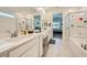 Bright bathroom featuring dual sinks, a bathtub, and a walk-in shower with white cabinets at 4364 Contour Bend Ave, North Las Vegas, NV 89084