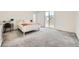 Bright bedroom with desk area, sliding doors to the back patio, and soft gray carpet at 4364 Contour Bend Ave, North Las Vegas, NV 89084