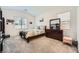 Cozy bedroom featuring plush carpeting, a comfortable bed, and a classic dark wood dresser at 4364 Contour Bend Ave, North Las Vegas, NV 89084