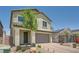 Charming two-story home with desert landscaping, a paver driveway and entry. A tree in the yard adds curb appeal at 4364 Contour Bend Ave, North Las Vegas, NV 89084