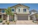 Two-story home featuring a charming facade, desert landscaping, and a brick paver driveway leading to an attached two-car garage at 4364 Contour Bend Ave, North Las Vegas, NV 89084