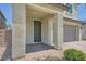 View of the front entrance with a covered porch and brick pavers, creating a welcoming entrance to the home at 4364 Contour Bend Ave, North Las Vegas, NV 89084