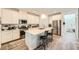 Modern kitchen with white cabinets, stainless steel appliances, and a large island with bar seating at 4364 Contour Bend Ave, North Las Vegas, NV 89084