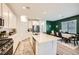 Open kitchen and dining area featuring modern appliances, ample counter space, and stylish, wood-look flooring at 4364 Contour Bend Ave, North Las Vegas, NV 89084