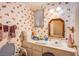 Bright bathroom featuring wallpaper, framed mirror, and a white vanity and countertop space at 4539 Peardale Dr, Las Vegas, NV 89147